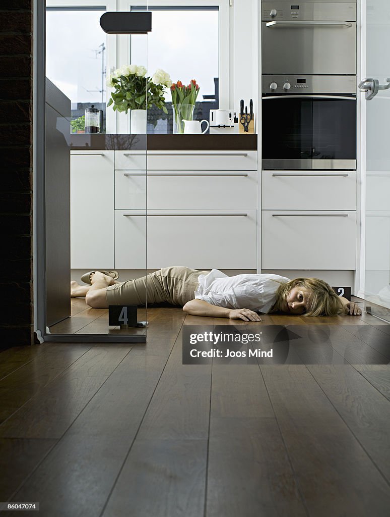 Woman lying on kitchen floor, murdered