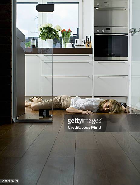 woman lying on kitchen floor, murdered - dead women stock pictures, royalty-free photos & images