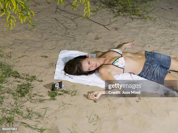 woman lying on beach, murdered - dead body sand stock pictures, royalty-free photos & images