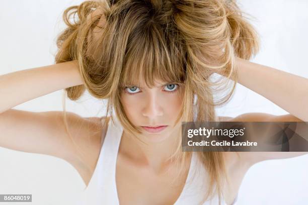 teenage girl pulling out hair - touching hair stock pictures, royalty-free photos & images