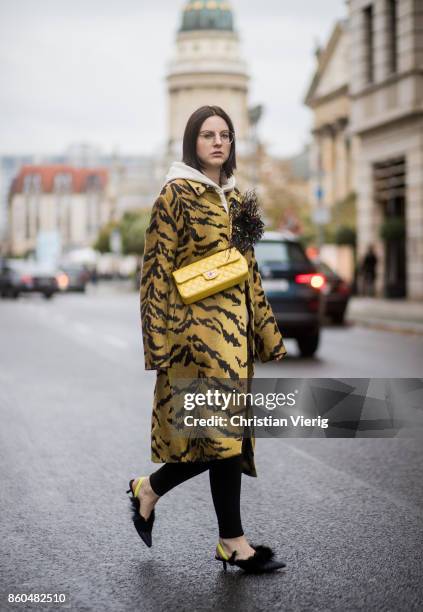 Fashion blogger Maria Barteczko wearing a tiger jacquard coat Christopher Kane, Off White printed hoody Charms, black skinny jeans Saint Laurent,...