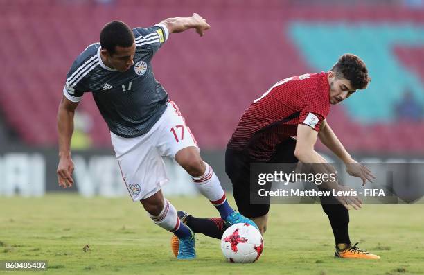 Fernando Cardozo of Paraguay and Kerem Kesgin of Turkey challenge for the ball during the FIFA U-17 World Cup India 2017 group B match between Turkey...