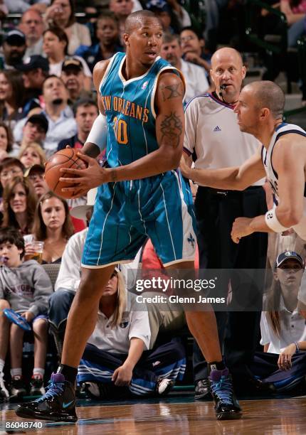 David West of the New Orleans Hornets looks to pass against Jason Kidd of the Dallas Mavericks during the game on April 10, 2009 at American Airlines...