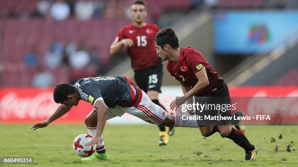 Blas Armoa of Paraguay is tackled by Emirhan Civelek of Turkey during the FIFA U-17 World Cup India 2017 group B match between Turkey and Paraguay at...