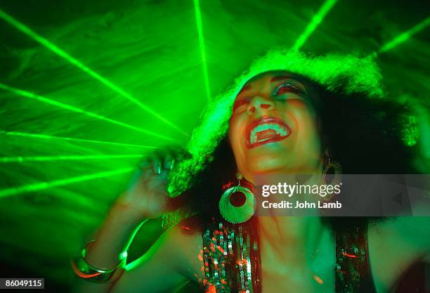 woman dancing in front of green laser - entertainer stock pictures, royalty-free photos & images