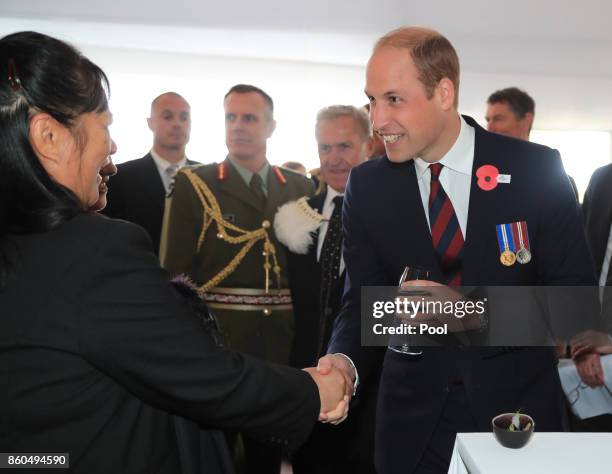 Prince William, Duke of Cambridge speaks to guests as he attends a reception for the Battle of Passchendaele at Tyne Cot Cemetery on October 12, 2017...