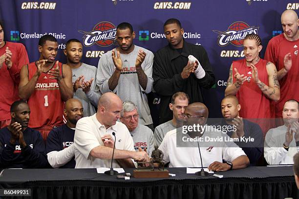 In front of the entire team, general manager Danny Ferry shakes the hand of head coach Mike Brown of the Cleveland Cavaliers after Mike Brown...