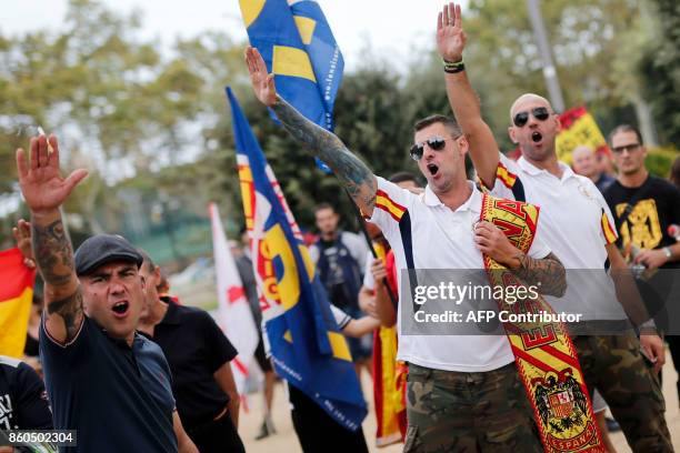 Protesters perform the fascist salute during an ultra-right wing anti-separatist demonstration for the unity of Spain called by "Falange Espanola"...