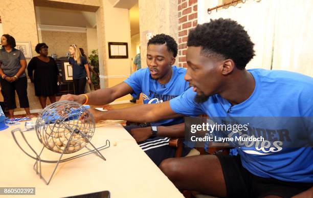 Semaj Christon and Daniel Hamilton of the Oklahoma City Thunder play bingo with local senior citizens on September 21, 2017 at the Brookdale Village...