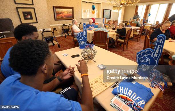 Semaj Christon and Daniel Hamilton of the Oklahoma City Thunder play bingo with local senior citizens on September 21, 2017 at the Brookdale Village...