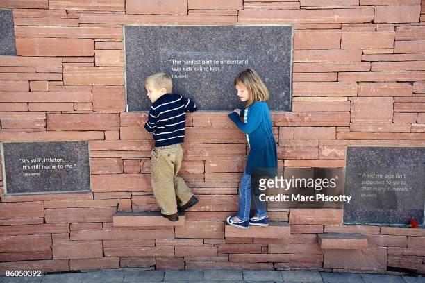 Asher Lankow and Lexi Lankow of Denver walk along the outside edge of the Columbine Memorial on the ten-year anniversary of the Columbine High School...