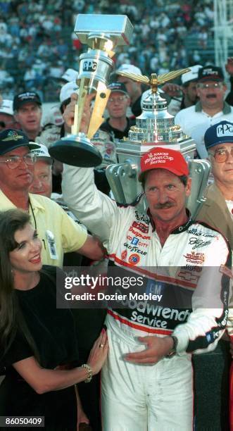 Driver Dale Earnhardt celebrates in Victory lane with wife Teresa Earnhardt after winning the Brickyard 400 race on August 5, 1995 at the...