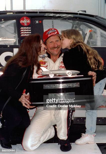 Driver Dale Earnhardt celebrates in Victory Lane with wife Teresa Earnhardt and daughter Taylor Earnmhardt after winning the Daytona 500 race on...