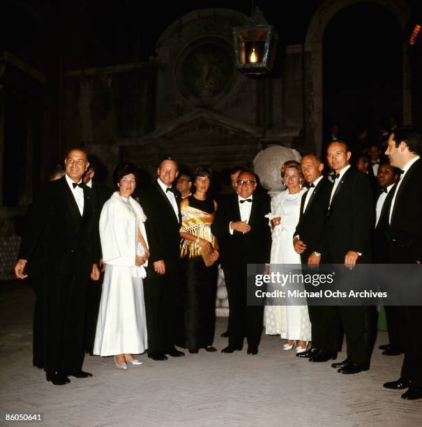 The Apollo 11 astronauts and their wives pose for a portrait at a reception with the President of the Council of Ministers Mariano Rumor at the...