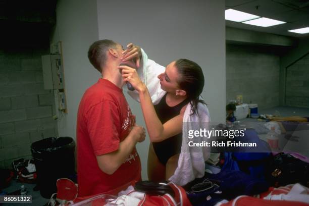 Synchronized Swimming: Portrait of Team USA Bill May getting a quick shave from teammate Lauren McFall before a television interview. Federal Way, WA...