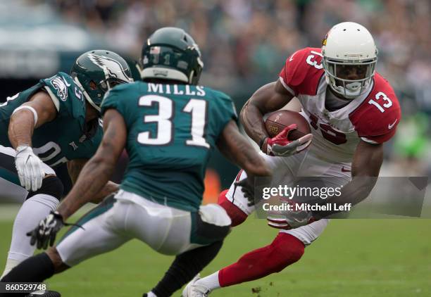 Jaron Brown of the Arizona Cardinals runs with the ball against Mychal Kendricks and Jalen Mills of the Philadelphia Eagles at Lincoln Financial...