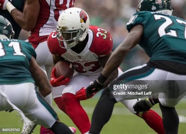 Kerwynn Williams of the Arizona Cardinals runs the ball against Jalen Mills and Malcolm Jenkins of the Philadelphia Eagles at Lincoln Financial Field...