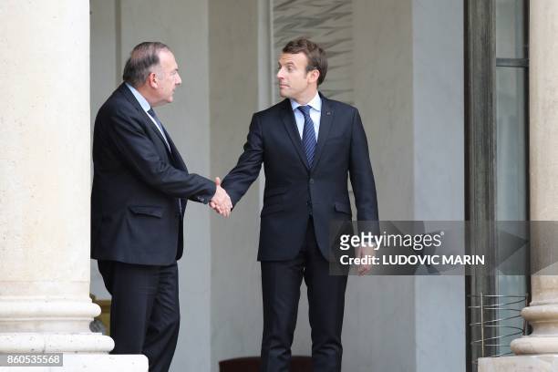 French President Emmanuel Macron shakes hand with head of the employers federation MEDEF, Pierre Gattaz following their meeting at the Elysee Palace...
