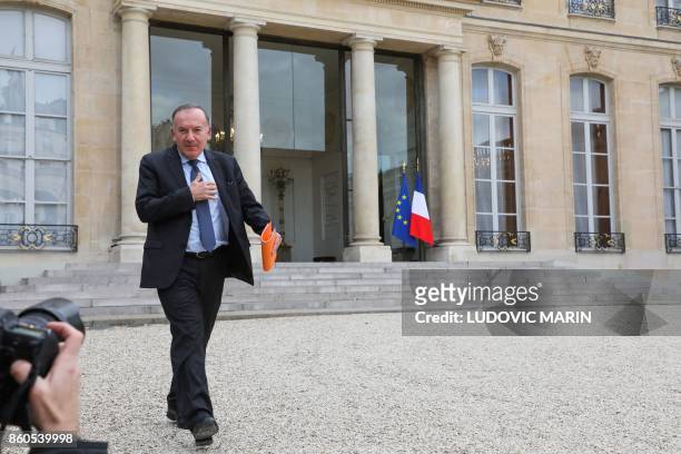 Head of the employers federation MEDEF, Pierre Gattaz gestures as he walks past a press photographer, as he leaves following a meeting with the...