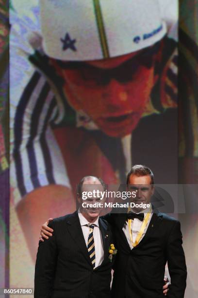 Sport Australia Hall of Fame Inductee and legend Cyclist Brad McGee poses with Ryan Bailey on stage at the Annual Induction and Awards Gala Dinner at...