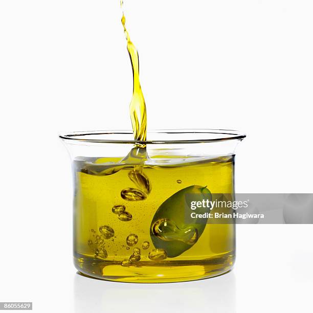 olive soaking in olive oil - olive oil ストックフォトと画像