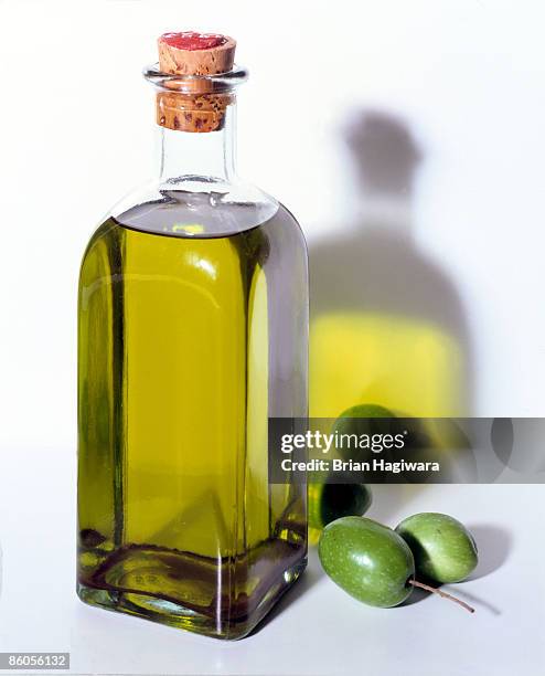 bottle of olive oil with olives - olive oil ストックフォトと画像