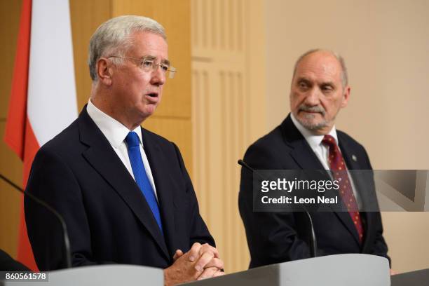 Poland's Defence Minister Antoni Macierewicz listens as Britain's Defence Secretary Michael Fallon addresses members of the media during a joint...