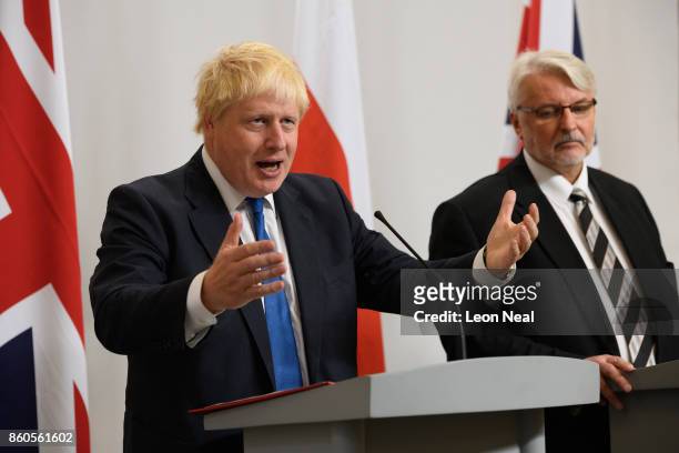 Poland's Foreign Minister Witold Waszczykowski looks on as Britain's Foreign Secretary Boris Johnson addresses members of the media during a joint...