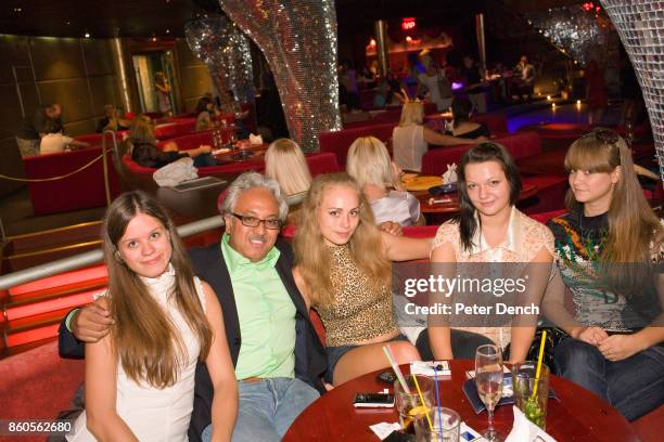 Robert sits with four young Ukranian women at a social event organised by The Anastasiaweb.com Experience at The Palladium Club, Odessa, where he...