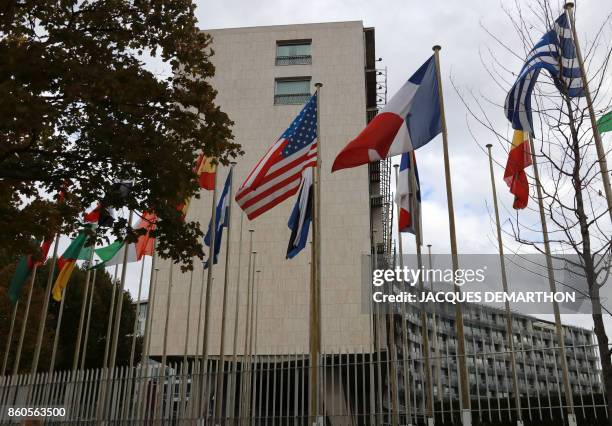 Picture taken on October 12, 2017 shows the flags flying in front of the United Nations Educational, Scientific and Cultural Organisation...