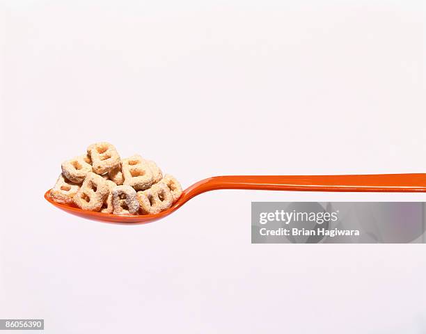 spoon with cereal shaped like a "b - ビタミンb3 ストックフォトと画像