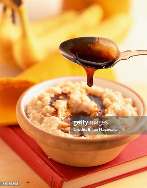 treacle over oatmeal - molasses stock pictures, royalty-free photos & images