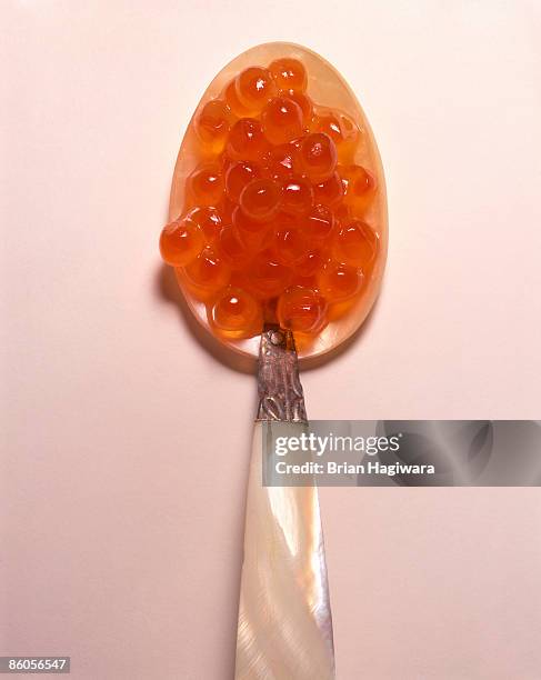 salmon caviar on spoon - kaviar stock-fotos und bilder