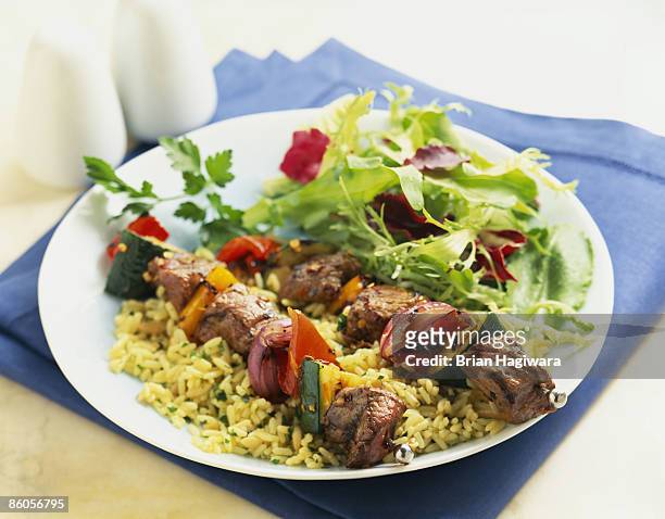 shish kabobs over rice with salad - skewer stock pictures, royalty-free photos & images