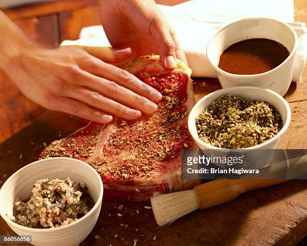 person seasoning porterhouse steak - spice stock pictures, royalty-free photos & images