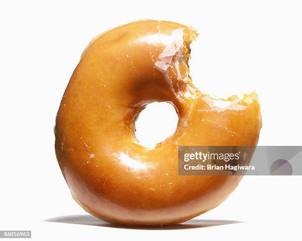 glazed doughnut with missing bite - glazed food stock pictures, royalty-free photos & images