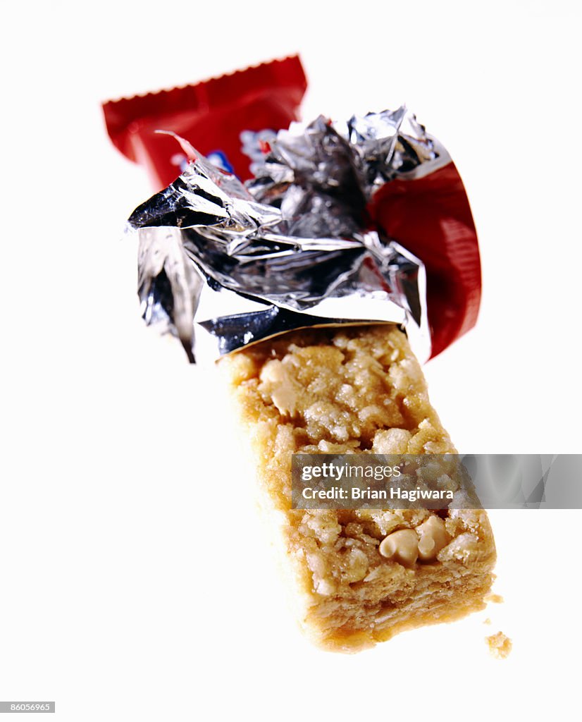 Unwrapped granola bar on white