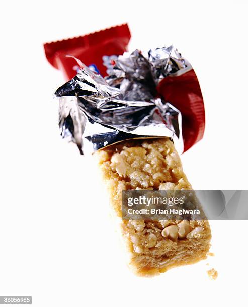 unwrapped granola bar on white - snack foto e immagini stock