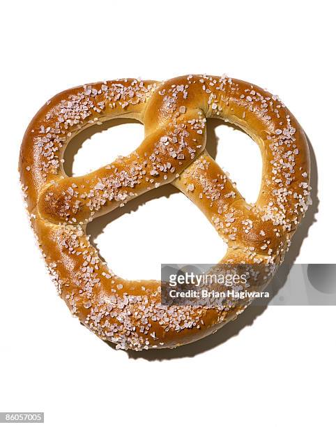 salted pretzel on white - salted fotografías e imágenes de stock