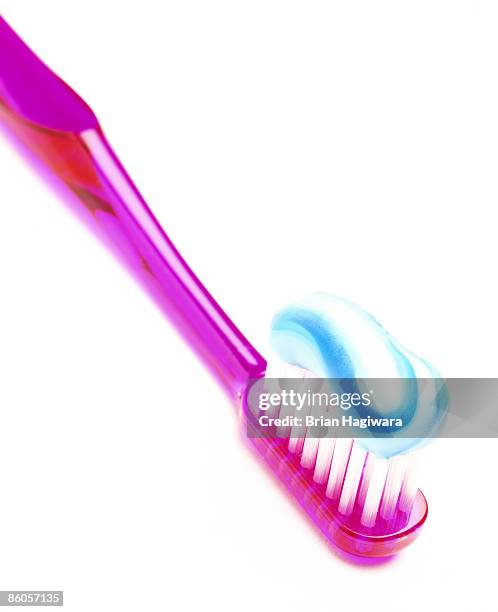 toothbrush with toothpaste on white - zahnpasta stock-fotos und bilder