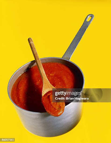 tomato sauce in pan with wooden spoon - pots and pans stock pictures, royalty-free photos & images