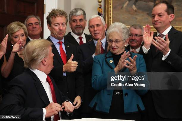 Sen. Rand Paul shows a thumbs up to President Donald Trump during an executive order signing as Vice President Mike Pence, Rep. Virginia Foxx and...