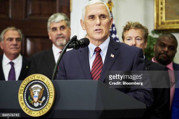 Vice President Mike Pence speaks before U.S. President Donald Trump, not pictured, signs an executive order on health care in the Roosevelt Room of...
