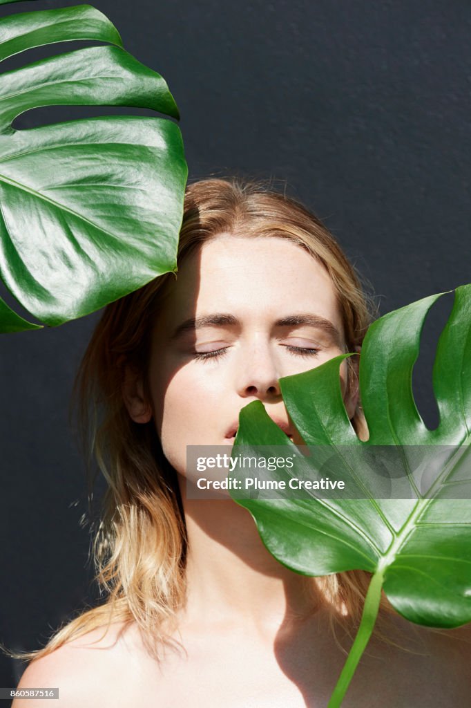 Woman with lush green foliage