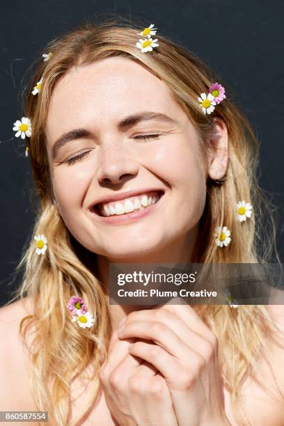 woman smiling with daisies in hair - daisy chain stock pictures, royalty-free photos & images