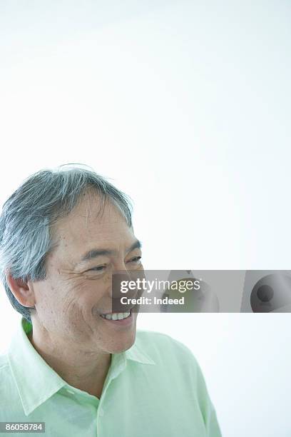 senior man smiling, looking away - hawaii hemd stock-fotos und bilder