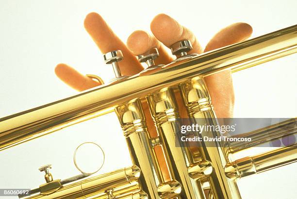 musician's hand playing trumpet - trompet stockfoto's en -beelden