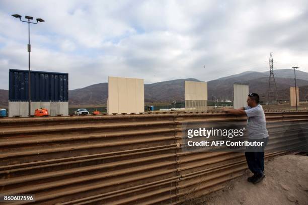 Man watches across the border from Tijuana, Mexico, on October 12, 2017 a prototype of US President Donald Trump's US-Mexico border wall being built...