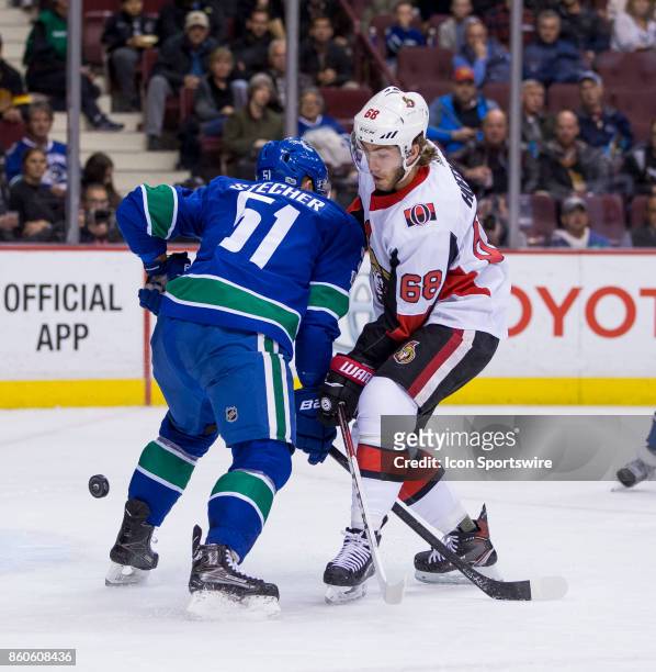 Vancouver Canucks Defenceman Troy Stecher checks Ottawa Senators Left Wing Mike Hoffman during a NHL hockey game on October 10 at Rogers Arena in...