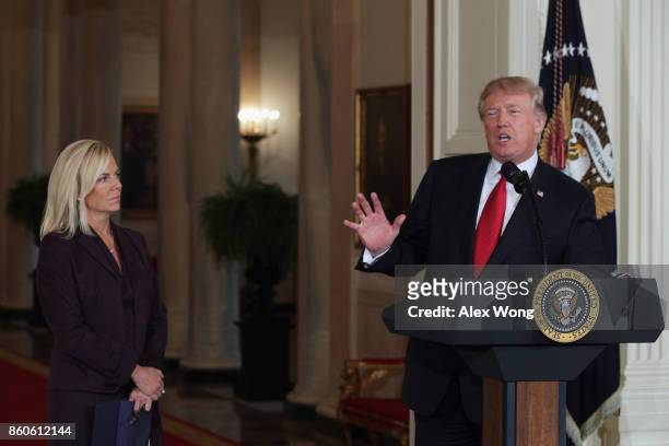President Donald Trump speaks as White House Deputy Chief of Staff Kirstjen Nielsen looks on during a nomination announcement at the East Room of the...